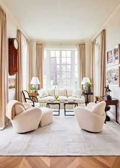 a living room filled with furniture and lots of windows