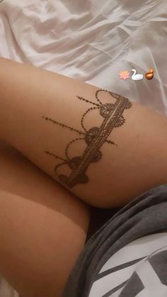 a person laying down with a tattoo on their leg