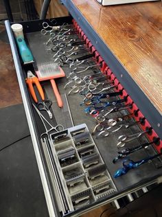 a drawer full of scissors and other tools