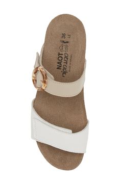 A rounded buckle stands out at the strap of a summery sandal set on a walkable wedge for everyday comfort and style. 1 1/4" heel (size 39) Adjustable hook-and-loop straps Cushioned footbed with arch support Leather upper and lining/synthetic sole Imported Cream Leather Sandals With Arch Support, Everyday Sandals With Removable Insole And Wedge Heel, Beige Adjustable Wedge Sandals With Buckle Closure, Adjustable Beige Wedge Sandals With Buckle Closure, Adjustable White Wedge Sandals With Buckle Closure, White Wedge Sandals With Buckle Closure, White Adjustable Sandals For Everyday Wear, White Sandals With Leather Footbed For Everyday, Everyday White Sandals With Leather Footbed