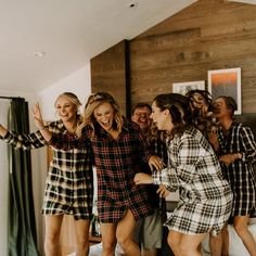 a group of women standing around each other in pajamas