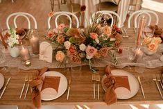 the table is set with flowers and candles