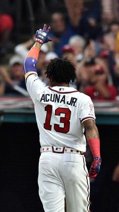 a baseball player holding his hand up in the air