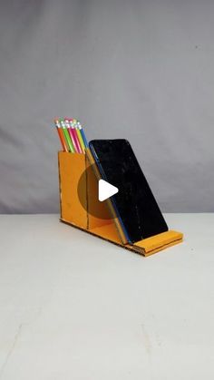 a desk organizer with pens and pencils in it