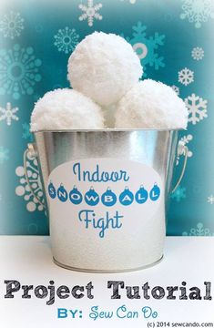 a bucket filled with snowballs sitting on top of a white table next to a blue wall