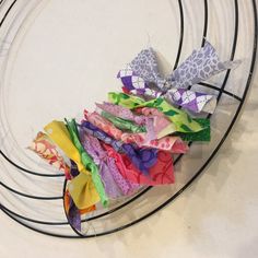 several pieces of fabric sitting on top of a wire rack in front of a white wall