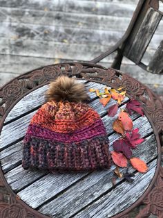 Beautiful Autumn Dreams beanie is ready to take you from fall to winter, in style!  Shades that mimic the autumn leaves from gold, to reds to browns, you will love the gorgeous earthy tones as you get the looks in this stylish hat. Perfect gift for someone who needs to keep warm during the cold season.  Colorful 100% acrylic yarn, that is super thick and a nice fitted beanie to keep you warm and stylish! Topped with a faux fur Pom. Poms will vary due to availability but will be warm tone . Hand washing recommended , paying attention not to submerse Pom.  Lay flat to dry. Hat is a fitted style and will fit most average size women. This is a chunky knit hat and will keep you nice and toasty. Chunky Yarn Beanie, Yarn Beanie, Average Size Women, Girls Winter Hats, Colorful Hat, Chunky Knit Hat, Fall Hats, Warm Winter Hats, Stylish Hats