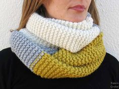 a woman wearing a knitted cowl with two different colors on the bottom and sides