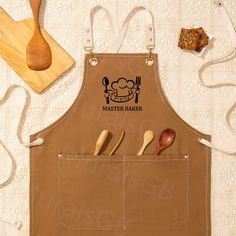 a brown apron with spoons and wooden utensils