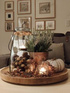 a table topped with a glass vase filled with plants