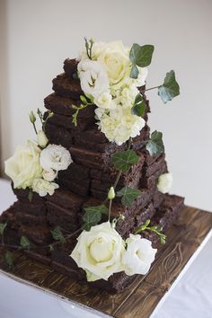 a chocolate cake with white flowers on top