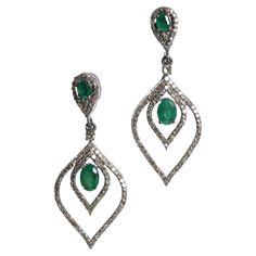 A pair of emerald and diamond tear drop dangle earrings. The post and center feature large, oval faceted emeralds and pave` set diamonds along the border. Emeralds total 1.78 carats; diamonds total 1.48 carats. Set in an oxidized sterling silver. Turquoise Earrings Dangle, Diamond Dangle Earrings, Emerald Earrings, Emerald Stone, Drop Dangle Earrings, Diamond Drops, Modern Earrings, Oxidized Sterling Silver, Diamond Drop Earrings