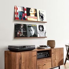 the entertainment center in this living room is made out of wood and has two speakers on each side