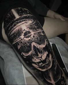 a man with a skull tattoo on his arm