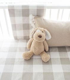 a stuffed animal sitting on top of a bed next to a pillow