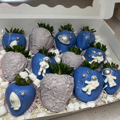 there are some blue and white strawberries in the shape of heart shaped balls with stars on them