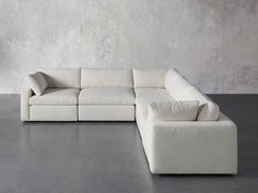 a white couch sitting on top of a cement floor