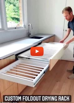 a man standing next to an open drawer in a kitchen with the words custom foldout drying rack