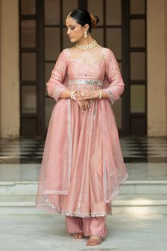 Onion pink padded anarkali with mirror embroidery. Comes with pant and a dupatta.
Components: 3
Pattern: Embroidered
Type Of Work: Mirror
Neckline: Sweetheart
Sleeve Type: Three quarter
Fabric: Semi crepe, Chanderi, Organza, Lining: Semi crepe
Color: Pink
Other Details: 
Attached lining
Product Weight: 1 Kg
Model Height: 5ft 9inches, wearing size S
Closure: Anarkali - Back tie-up
Occasion: Sangeet - Aza Fashions Anarkali Palazzo Set With Mirror Work For Reception, Anarkali Palazzo Set With Sheer Dupatta In Pink, Pink Anarkali Palazzo Set With Sheer Dupatta, Pink Anarkali Set With Gota Work For Reception, Anarkali Style Sharara With Mirror Work, Festive Anarkali Palazzo Set In Pink, Pink Anarkali Semi-stitched Palazzo Set, Pink Anarkali Palazzo Set For Festive Occasions, Bollywood Style Floor-length Palazzo Set With Mirror Work