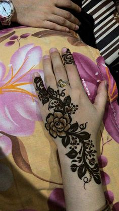 a woman's hand with henna on it