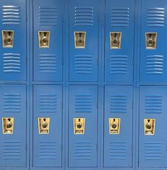 a row of blue lockers with gold handles