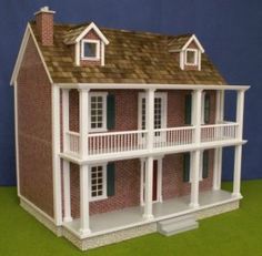 a doll house is shown on a green surface