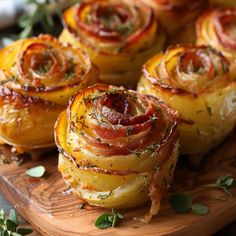 bacon wrapped potatoes on a wooden platter