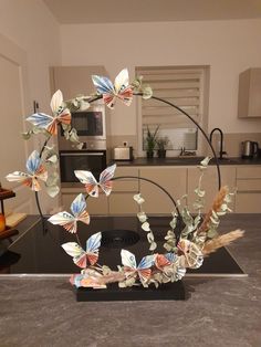 a kitchen counter top with a sculpture made out of paper butterflies