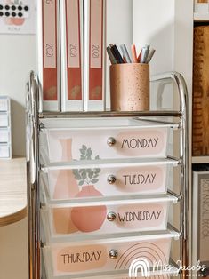 a metal cart with several drawers and pencils on it