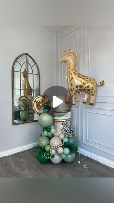 a giraffe balloon sculpture sitting on top of a table next to a mirror