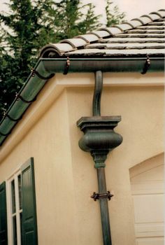 an image of a house with a roof that has a pipe coming out of it