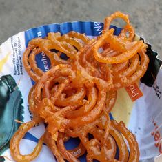 some onion rings sitting on top of a paper plate