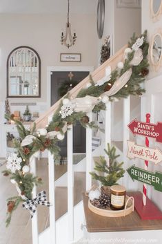 christmas decorations on the banisters and handrails in a home's entryway