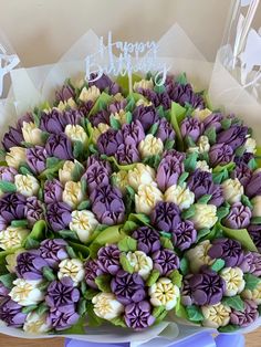 purple and white flowers in a bouquet on a table