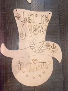 a wooden sign that says let it snow