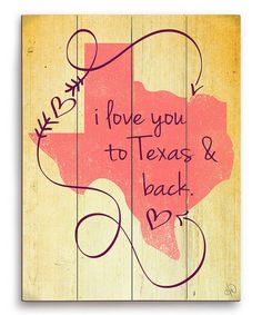 a wooden sign with the words i love you to texas and back in pink on it