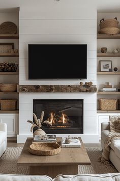 a living room filled with furniture and a flat screen tv mounted above a fire place