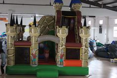 inflatable castle with slide and slides for children to play on at indoor event