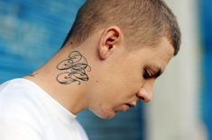 a man with a tattoo on his neck