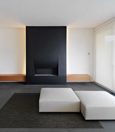 a black and white living room with an ottoman