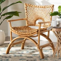 a wicker chair sitting on top of a rug next to a potted plant