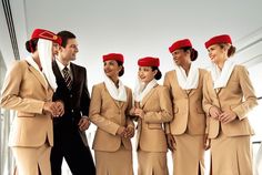 a group of air hostess standing next to each other