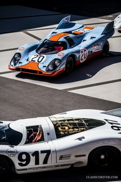 two race cars driving on a track next to each other