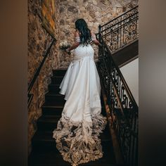 a woman in a wedding dress is walking down the stairs