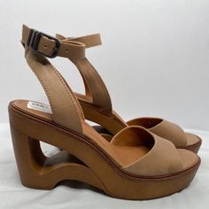 Lucky Brand Wyndin Style Sculpted Heel Sandal Color In Tan Upper In Leather Ankle Strap In Leather Adjustable Ankle Strap With Buckle Closure Open Toe Rounded Toe Women's Size 7.5m New With Store Tag No Box Heel Height Approximately 3 3/4" Platform Height Approximately1/2" Rubber Sole Item Ships With A 360 Security Tag In Place With Serial Number And Tamper-Evident Seal. Item Is Photographed With Tag In Place When Shipped. No Returns Accepted If Tag Is Removed Or Tampered With. Measurements Are Summer Leather Heels With Cushioned Footbed, Modern Wedge Sandals With Stacked Heel And Round Toe, Modern Sandals With Heel Strap And Round Toe, Adjustable High Heel Sandals With Stacked Heel, Adjustable Sandals With Stacked High Heel, Spring Leather Wedge Sandals With Removable Insole, Sandals With Wrapped Heel And Medium Width Open Heel, Leather Wedge Heel Sandals For Spring, Spring Sandals With Heel Loop And Round Toe