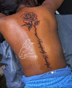 a woman with a rose tattoo on her back