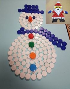 a snowman made out of plastic buttons on a table next to an image of a penguin