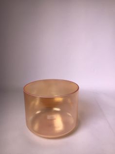 an empty glass bowl sitting on top of a white table