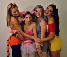 four girls dressed up in bunny ears and dresses posing for the camera with each other