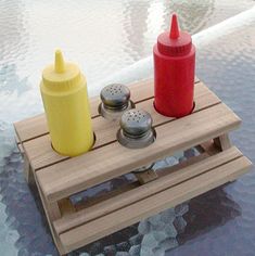 two crayons sitting on top of a wooden crate in the water next to each other